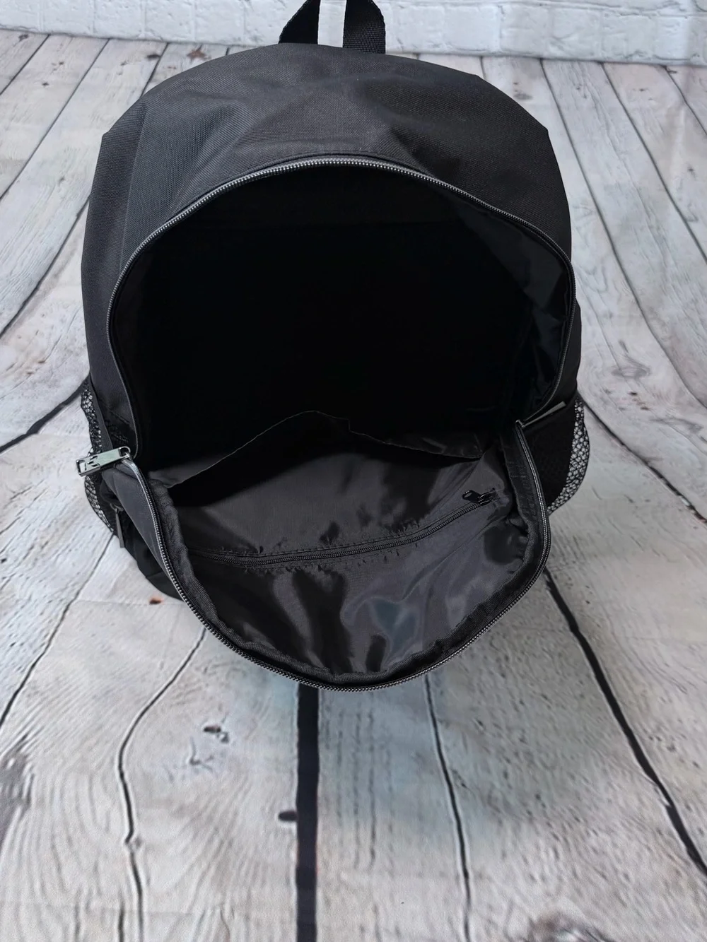Black Messi backpack with graphic of a soccer player in action